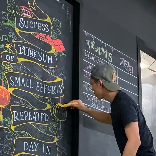 Chalk lettering mural in progress at Designate Studio